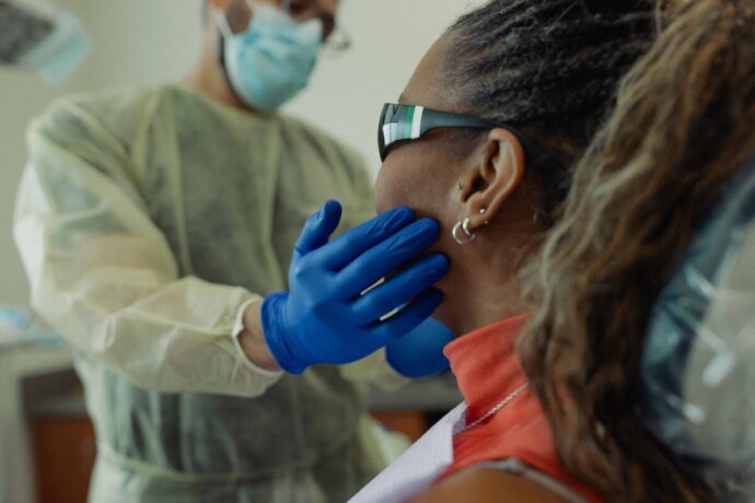 Dental care UT Health San Antonio provider working with a patient on oral medicine
